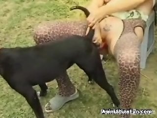 Busty blonde is giving that black dog a nice lip service